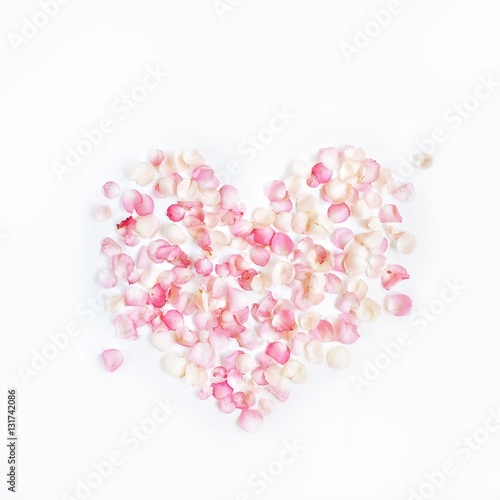 Heart symbol made of pink rose petals. Valentine's day background. Flat lay, top view