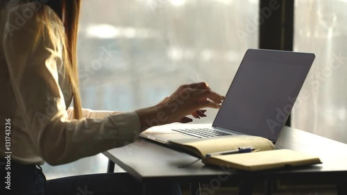 Close-up of busy female hand typing on keyboard while sitting at her working place in the office