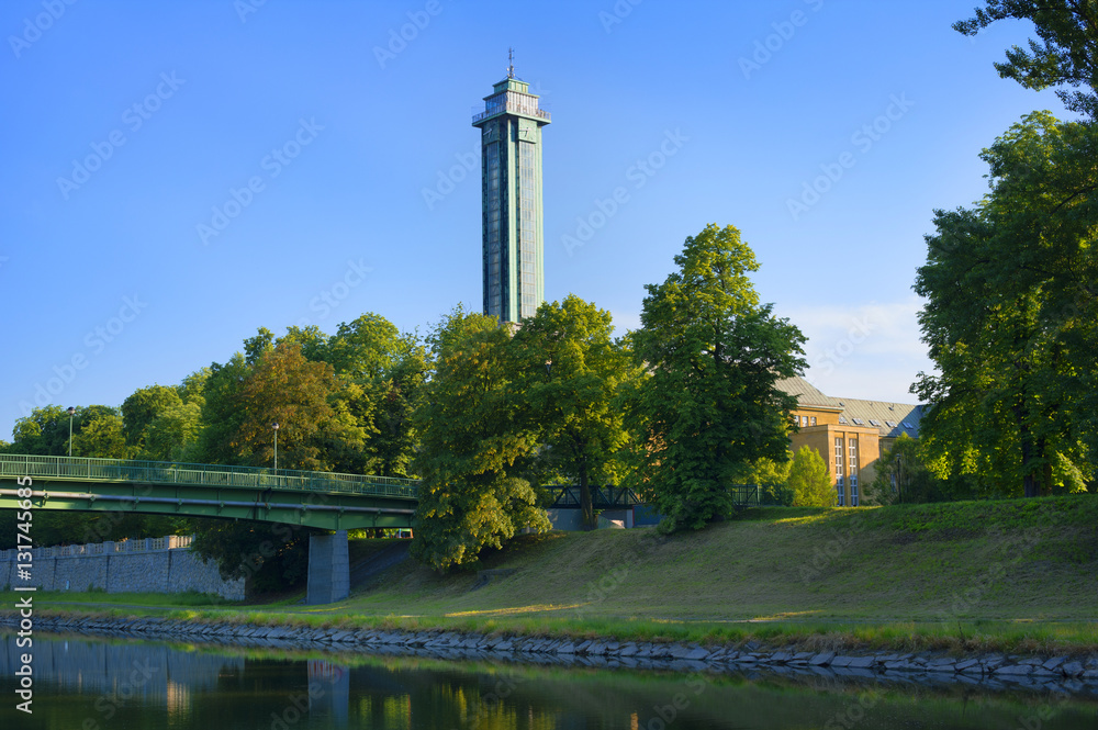 Ostravice river, Komenskeho sady park, Ostrava, Czech Republic / Czechia - evening scenery of beautiful nature of park in the center of the city. Tower, Building of New Town hall, in the background. 