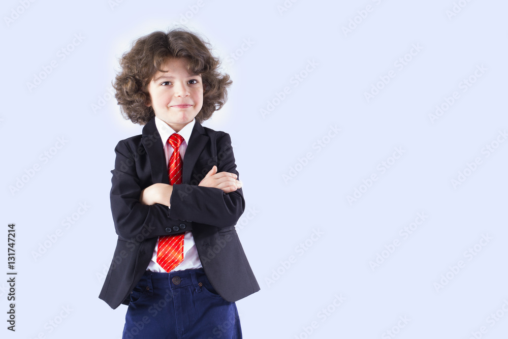 Curly small businessman with his arms crossed smiling and looking at the camera. Gray background. Curly small businessman with his arms crossed smiling and looking at the camera. Gray background.