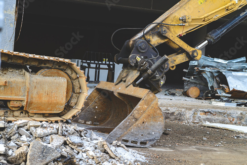 Bucket bulldozer removes construction waste photo