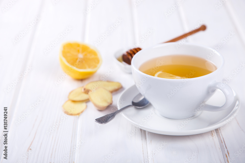 Cup of Ginger Tea with Lemon and Honey on a White Background.Concept Of Healthy Eating. Copy space. selective focus. Cup of Ginger Tea with Lemon and Honey on a White Background.Concept Of Healthy Eating. Copy space. selective focus.