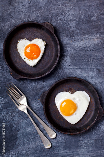 Fried egg in heart shape on the pan.Holiday Valentine's Day.Breakfast. Healthy Food.selective focus.