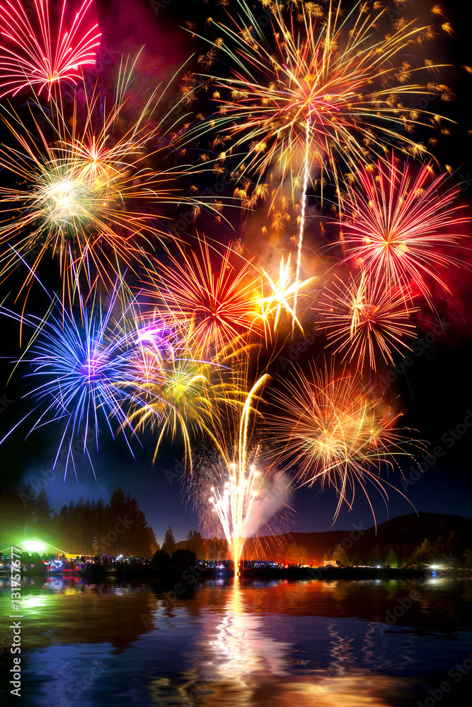 Fireworks display over lake with reflection Fireworks display over lake with reflection