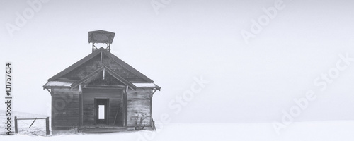 old abandoned school house in winter snow