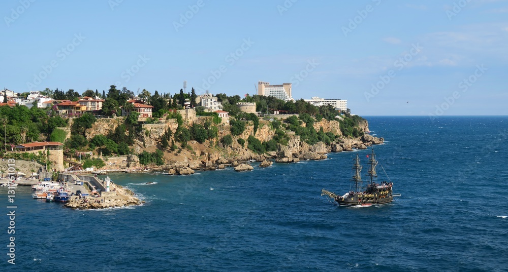 Sailing Ship entering the Harbour of Antalya with the Cliffs and Oldtown in the Background