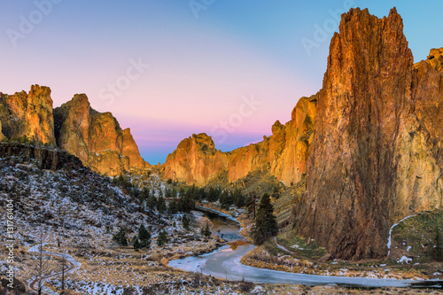 Winter sunrise at Smith Rock State Park with a dusting of snow and a frozen Crooked River.  photo
