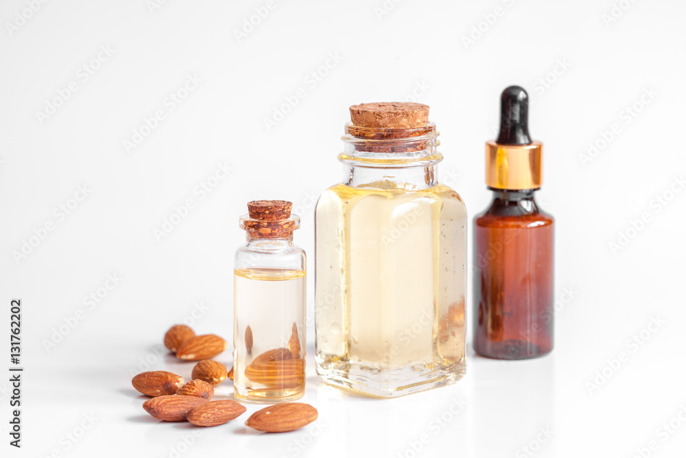 cosmetic almond oil in glass bottle on white background cosmetic almond oil in glass bottle on white background