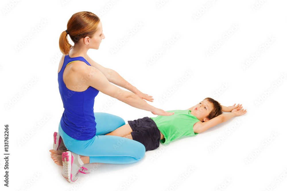 Kid boy making gymnastics with female trainer Kid boy making gymnastics with female trainer