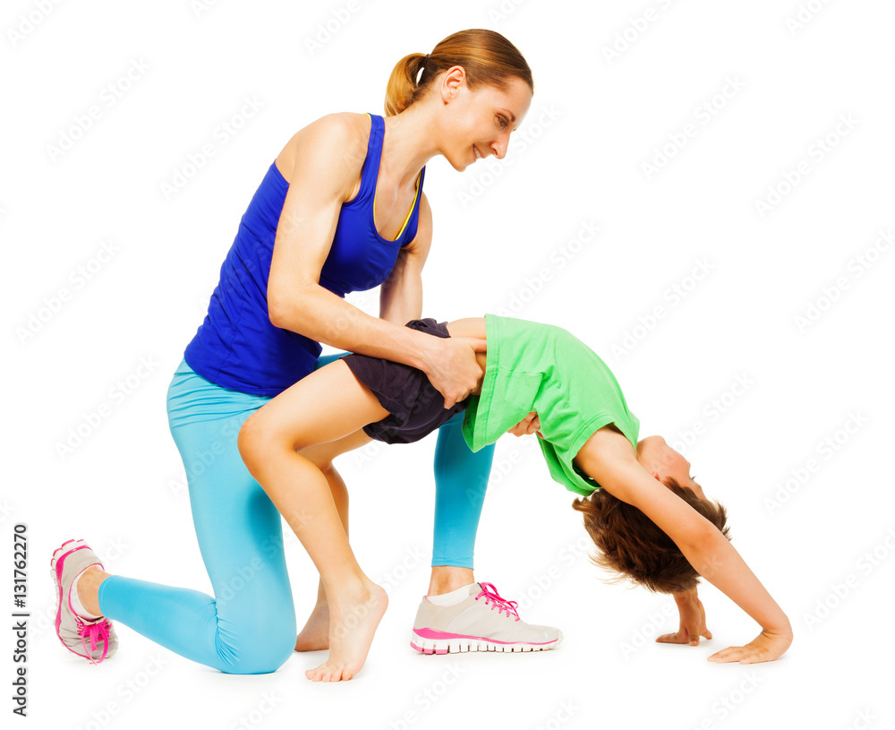 Fototapeta premium Mother helping her kid son making a crab position