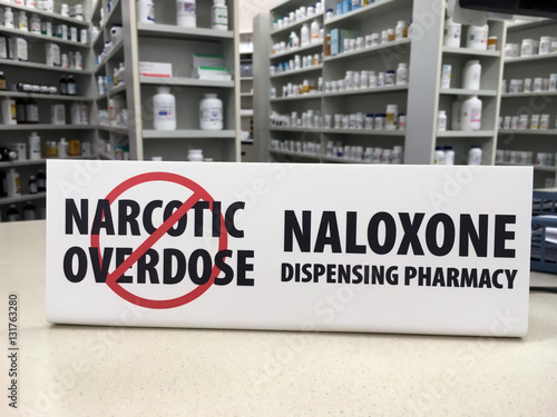 Naloxone sign showing pharmacy carries over the counter drug to prevent overdose