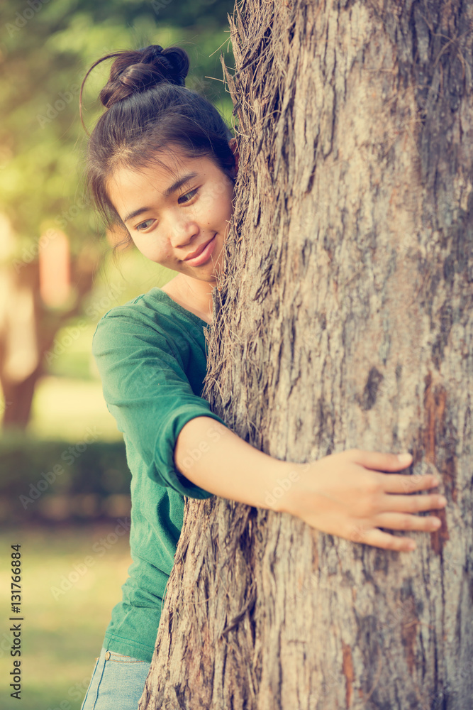 asian woman hugging a tree