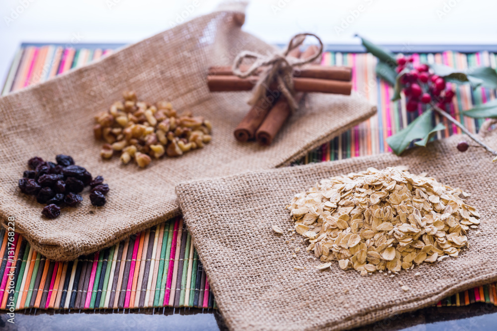Fototapeta premium Dry oatmeal with oatmeal breaksfast ingredients.