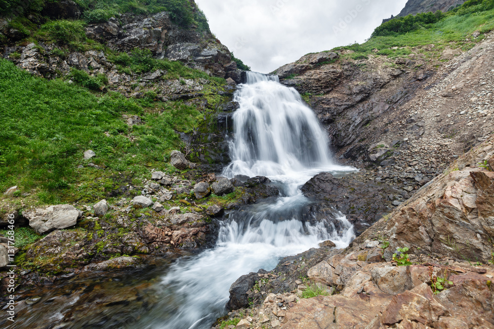 Mountain landscape of Kamchatka: beautiful waterfall