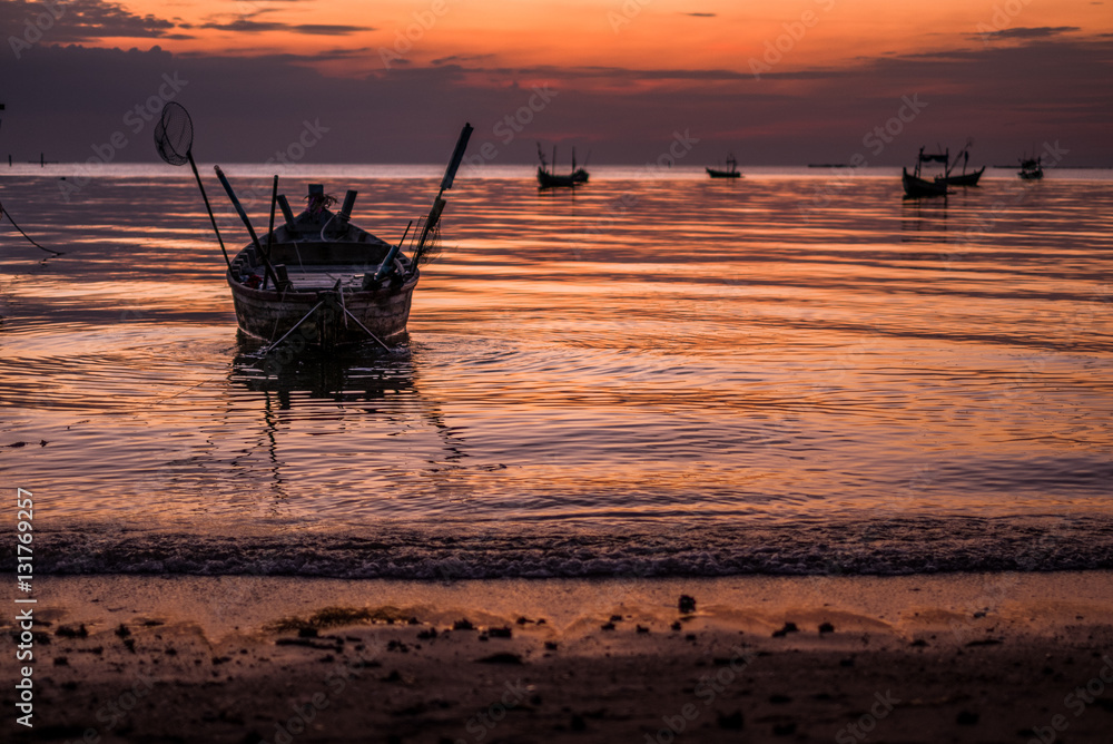 Beautiful sunset with fishing boat, vintage tone