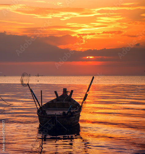 Beautiful sunset with fishing boat, vintage tone