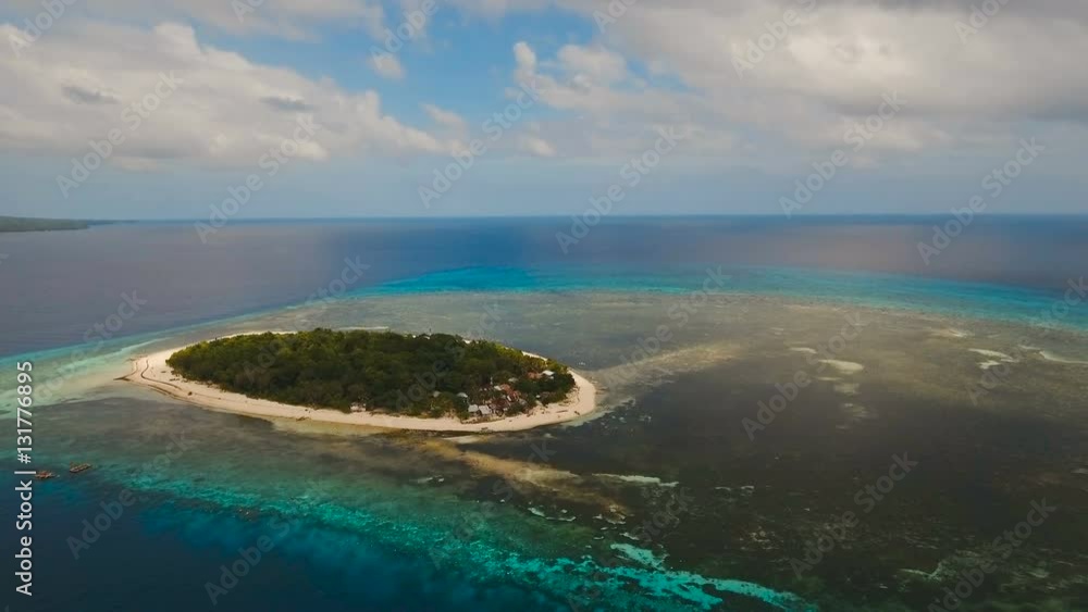 Aerial view of beautiful tropical island Mantigue with white sand beach. Beautiful sky, sea, resort. Seascape: Ocean and beautiful beach paradise. View of a nice tropical beach from the air Aerial view of beautiful tropical island Mantigue with white sand beach. Beautiful sky, sea, resort. Seascape: Ocean and beautiful beach paradise. View of a nice tropical beach from the air