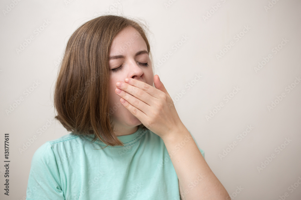 Portrait of blonde girl or young woman wearing blue green t-shirt with perplexed, puzzled, dumb, ignorant expression on her face scratching head with hand. When you don't know the answer Portrait of blonde girl or young woman wearing blue green t-shirt with perplexed, puzzled, dumb, ignorant expression on her face scratching head with hand. When you don't know the answer