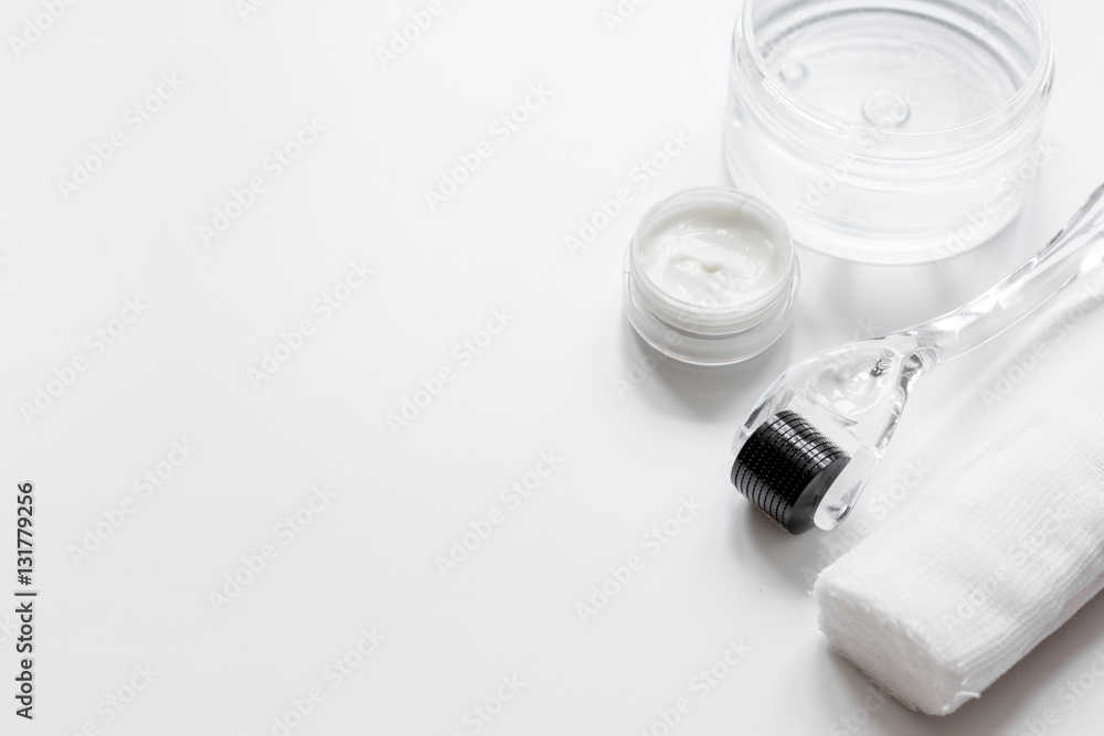 concept beautician desktop with mezoroller - mesotherapy on white background concept beautician desktop with mezoroller - mesotherapy on white background
