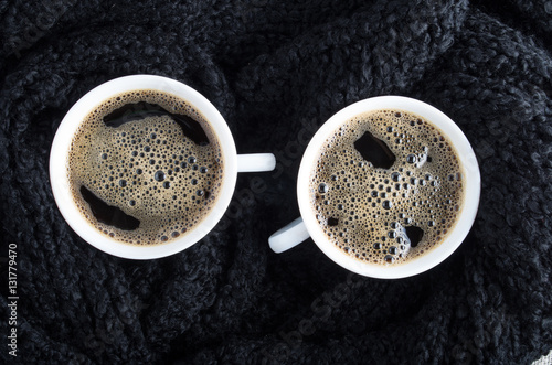 Cups of coffee and black woolen scarf
