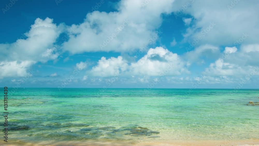 Panning Across Tropical Bermudan Waters on a Sunny Day with White Clouds in a Blue Sky Panning Across Tropical Bermudan Waters on a Sunny Day with White Clouds in a Blue Sky