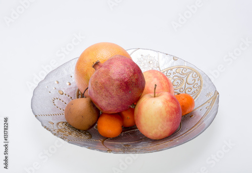 mix fresh fruits on plate isolated on white