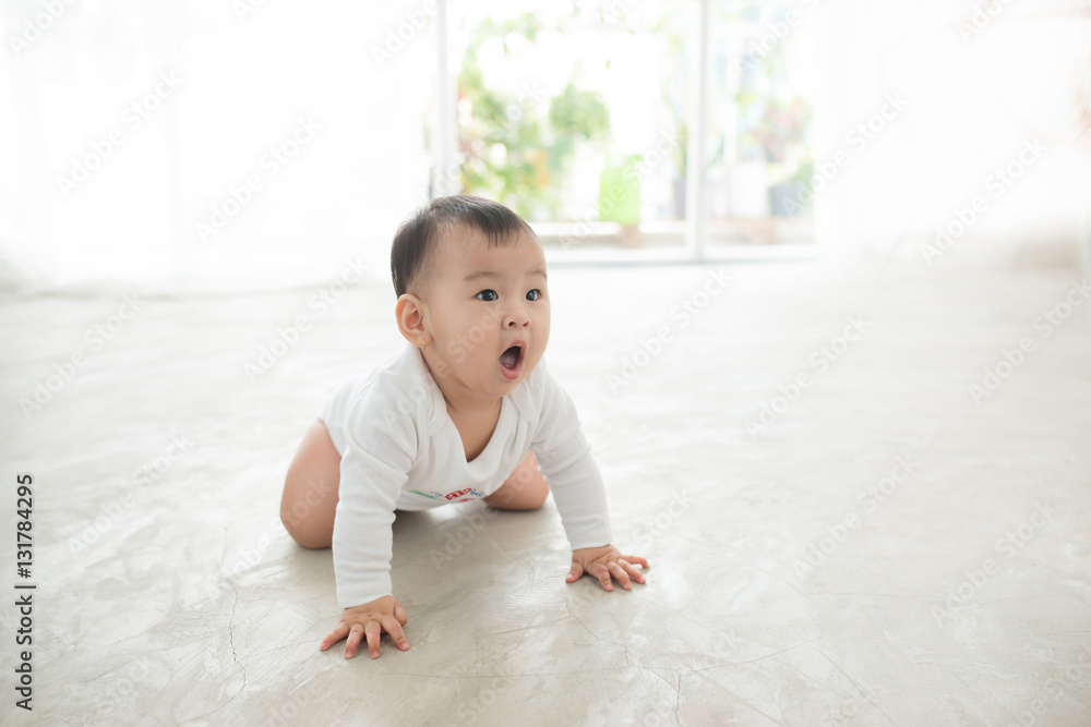 Little pretty baby girl crawling on the floor at home Little pretty baby girl crawling on the floor at home