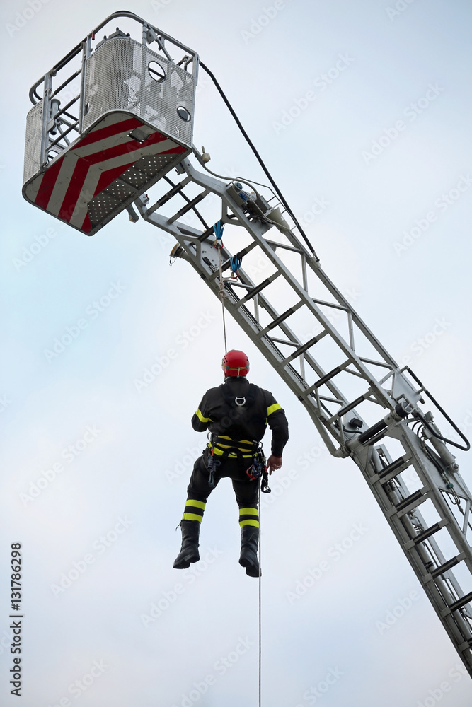 climber of firefighters with red helmet falls from the ladder tr