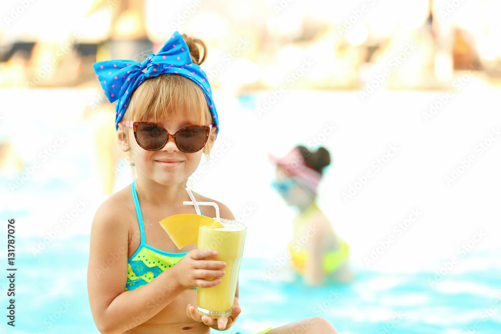 Little girl with cocktail at swimming pool on sunny day Little girl with cocktail at swimming pool on sunny day