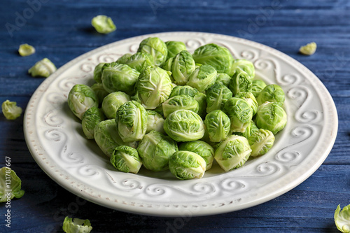 Plate with brussels sprouts on wooden table