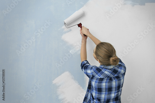 Beautiful young woman paint...