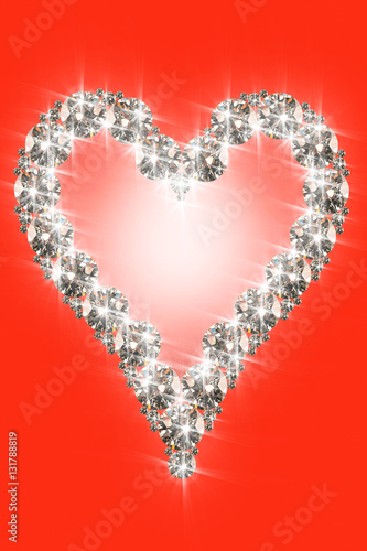 conceptual image of diamond heart over red background
