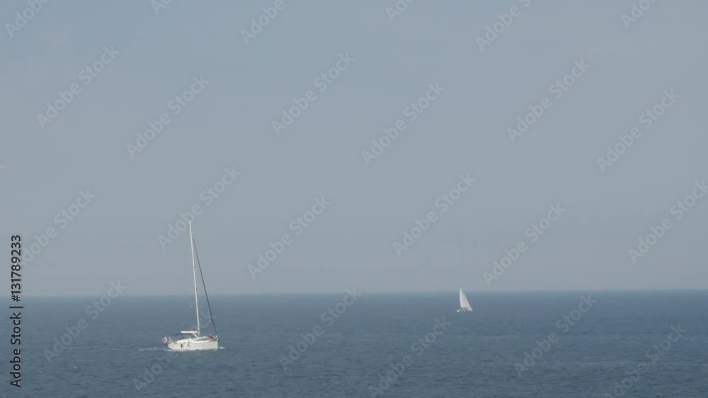 A sailboats on the horizon in the beautiful Mediterranean Sea. Day. A sailboats on the horizon in the beautiful Mediterranean Sea. Day.