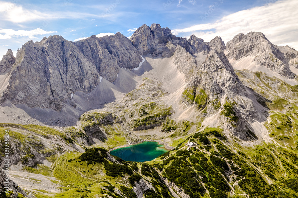 Panorama view of Drachensee lake with the mountains Gruenstein and Vorderer Drachenkopf in the state of Tirol / Tyrol in Austria.The lake with its cabin is a popular hiking destination for tourists.