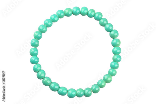 Green round elastic bracelet made of small pearl-like round beads, isolated on white background, clipping path included