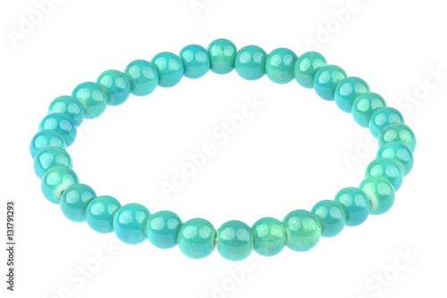 Turquoise elastic bracelet made of small pearl-like round beads, isolated on white background, clipping path included