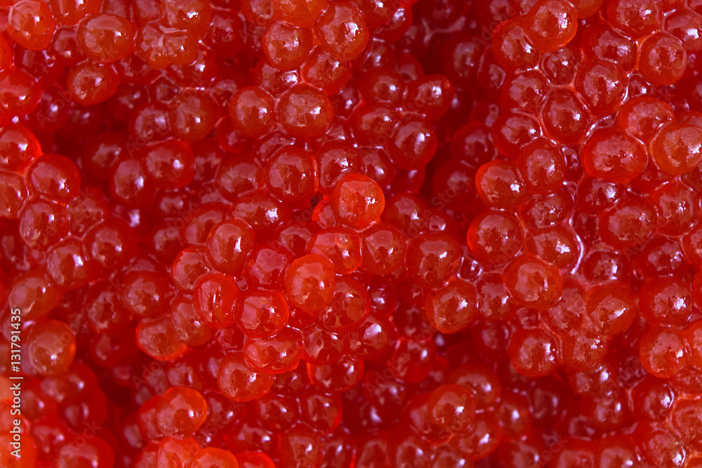 Red caviar close-up background. Background made of red caviar Red caviar close-up background. Background made of red caviar