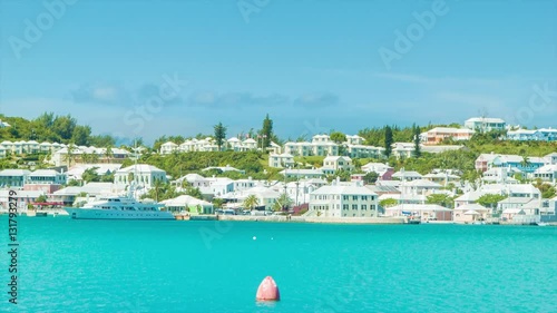 St. George's, Bermuda. Island Paradise! Featuring a Luxury Yacht,  and Buildings including Hotels, Apartment Buildings and other Hospitality Related Architecture Against the St. George's Harbor photo