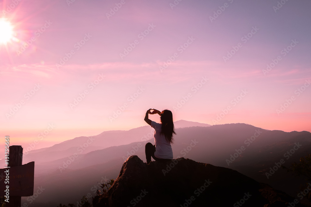 The silhouette of a woman Happy mountain morning sunrise.