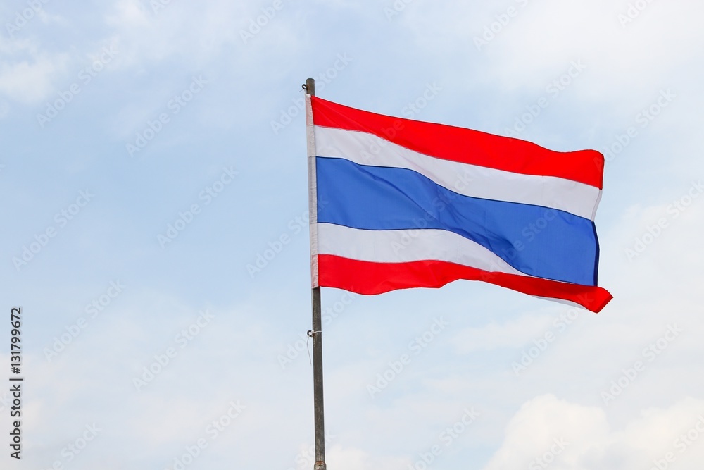 Thai flag, waving in the wind with beautiful with blue sky Thai flag, waving in the wind with beautiful with blue sky