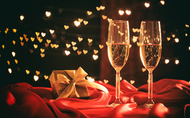 Champagne glasses on hearts bokeh background
