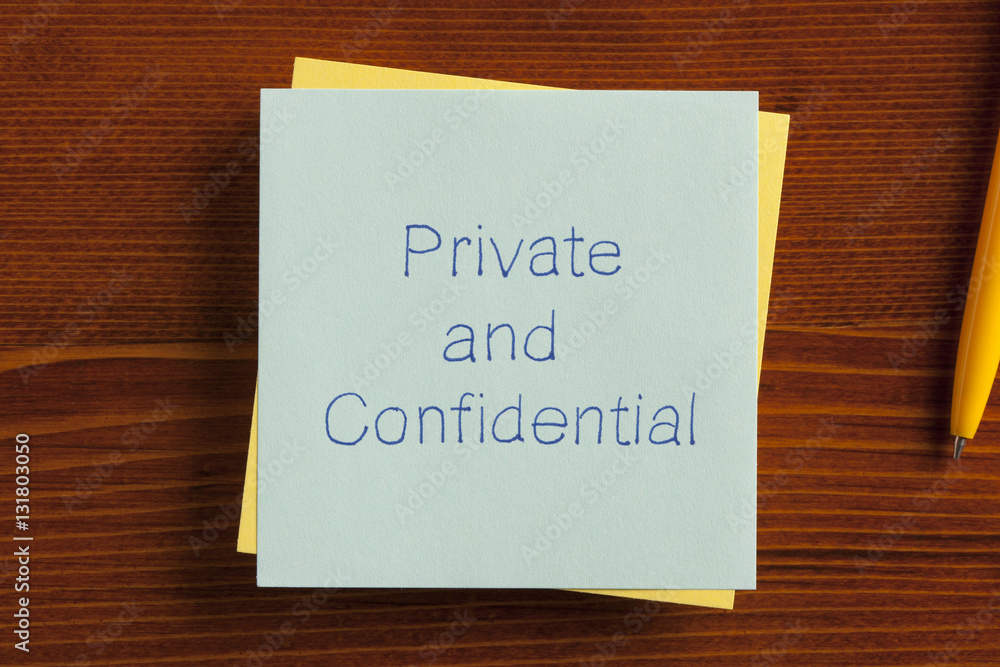 Private and Confidential written on a note Private and Confidential written on a note