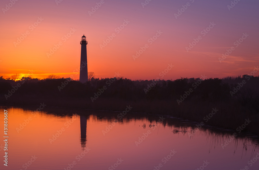 Lighthouse Silhouette reflecting on the water 