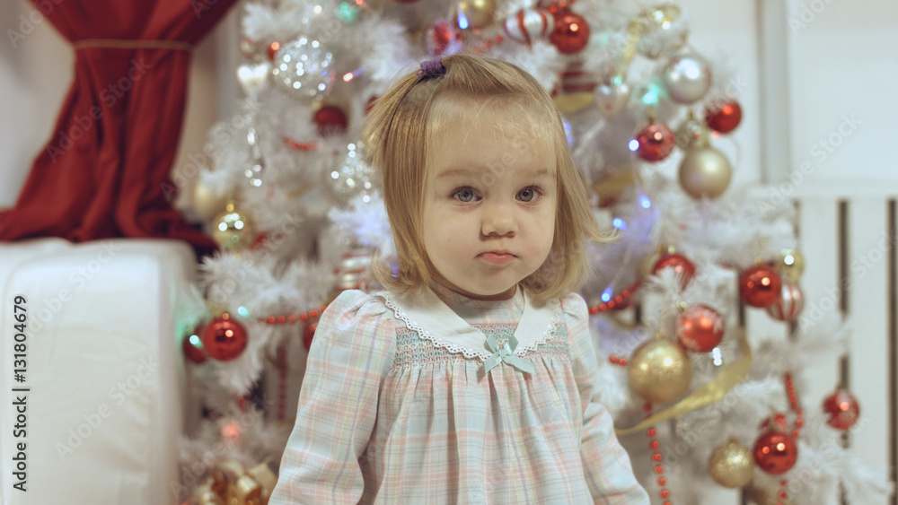 Cute little girl near the Christmas tree Cute little girl near the Christmas tree
