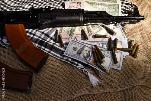 Combat weapons, US dollars and ammunition scattered