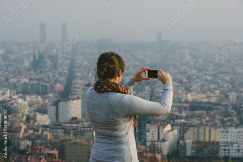 Girl taking picture of Barcelona panorama