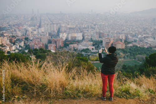 Girl taking picture of Barcelona panorama