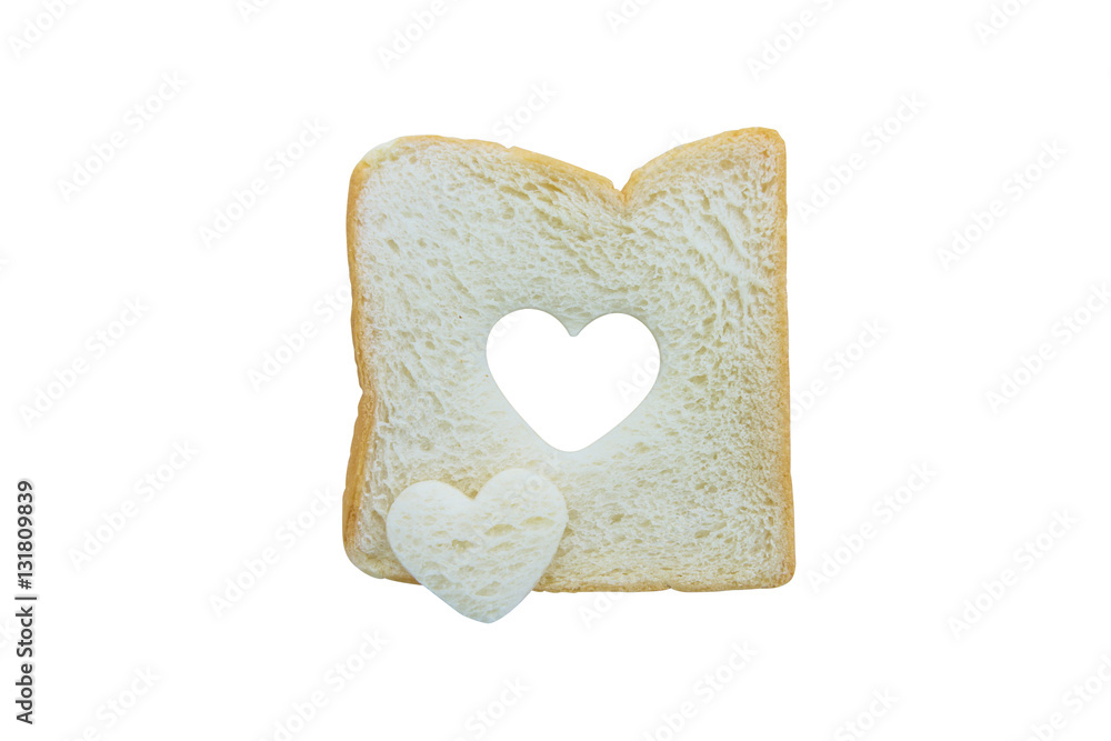 Heart shaped hole in a slice of bread isolated