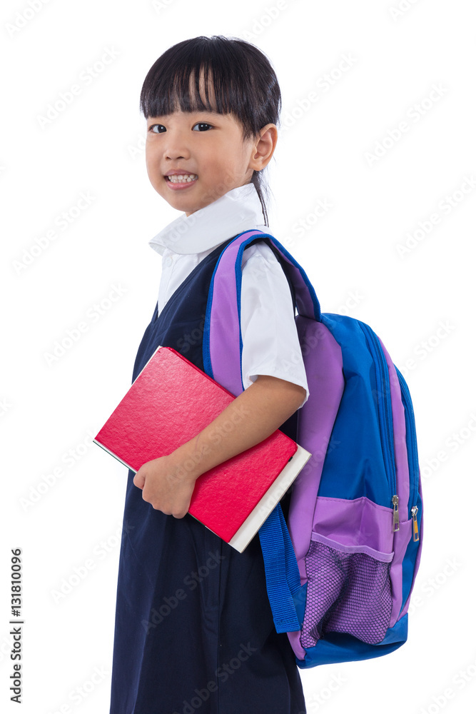 Asian Chinese little primary school girl holding books with bag Asian Chinese little primary school girl holding books with bag