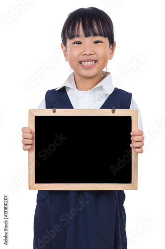 Happy Asian Chinese little primary school girl holding chalkboar photo